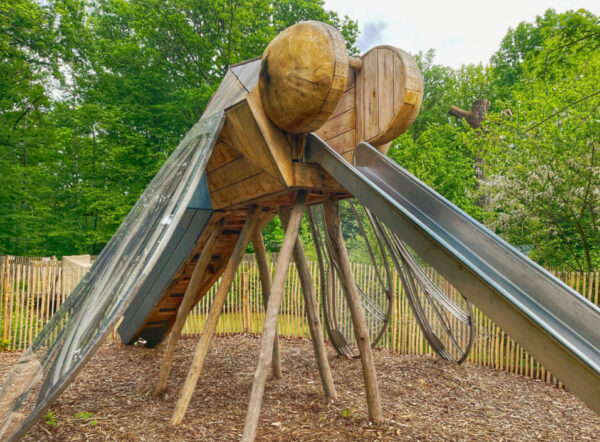 Afbeelding van een landmark sculptuur in de vorm van een libelle met een glijbaan geïntegreerd.